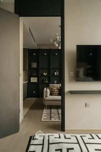 Modern living room with stylish decor and wall-mounted TV in a contemporary apartment.