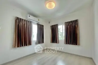 Bright empty room with large windows and air conditioning, perfect for customization.