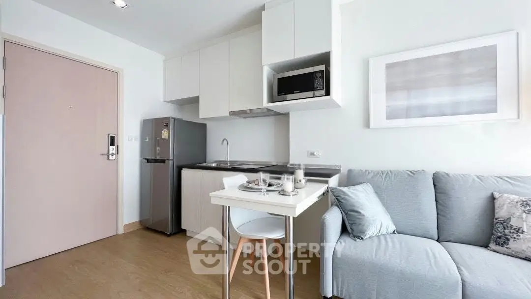 Modern compact kitchen and living area with sleek design and cozy ambiance.