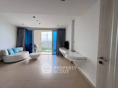 Spacious modern living room with panoramic city view and sleek furnishings.