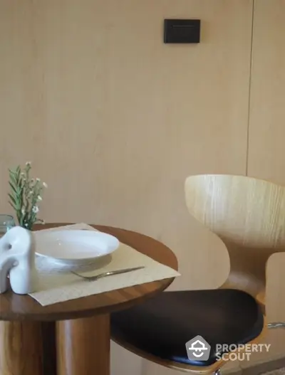 Stylish dining area with modern wooden chair and table setting