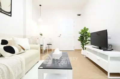 Modern living room with minimalist decor and cozy seating area.