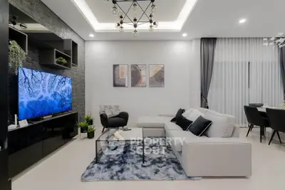 Modern living room with stylish decor and large TV, perfect for relaxation and entertainment.
