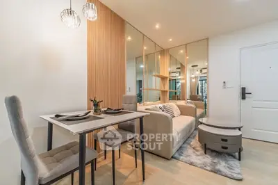 Modern living room with stylish decor and dining area in a cozy apartment.