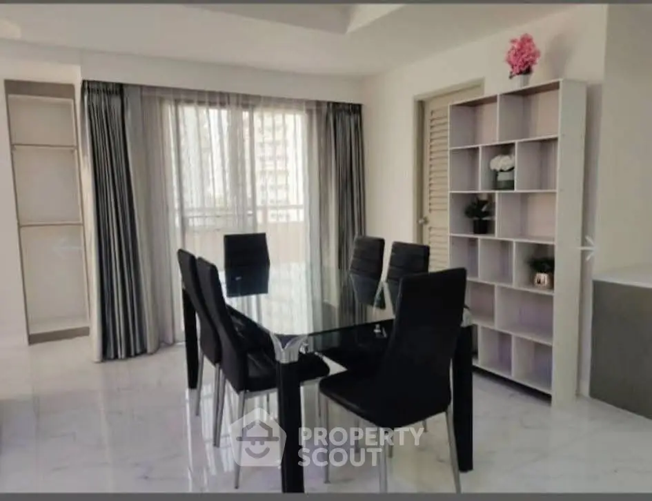 Elegant dining area with glass table and modern chairs in a bright apartment