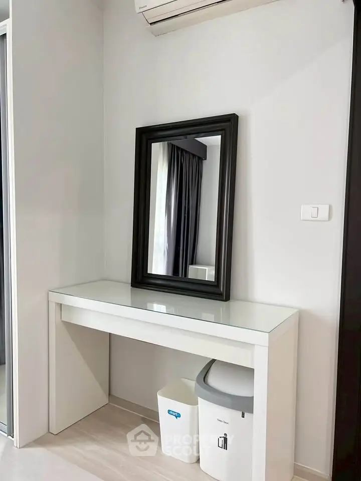 Modern minimalist interior with sleek mirror and air conditioning, perfect for stylish living.