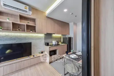 Modern kitchen and living area with sleek wooden cabinetry and stylish decor.