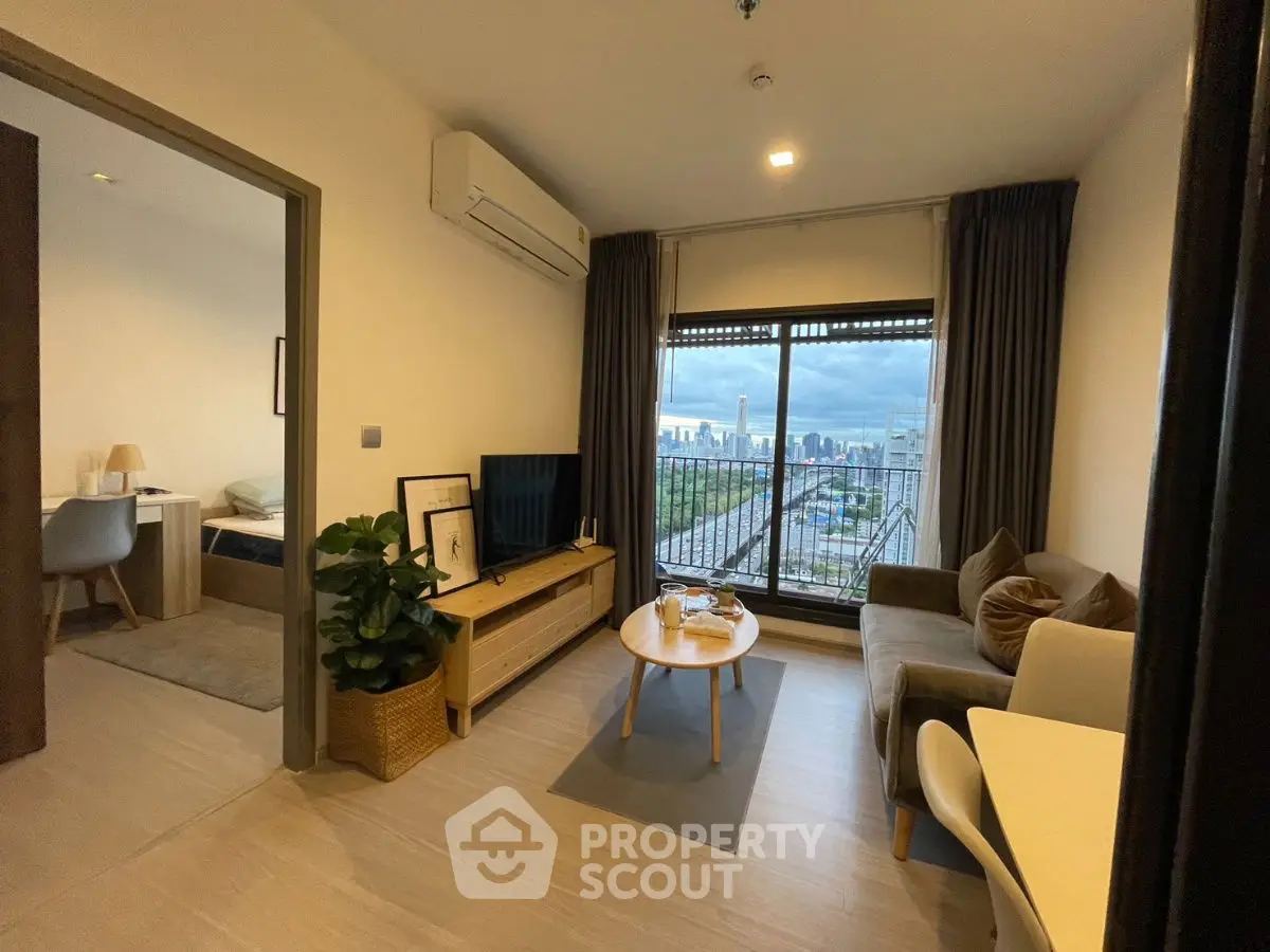 Modern living room with city view, cozy sofa, and stylish decor