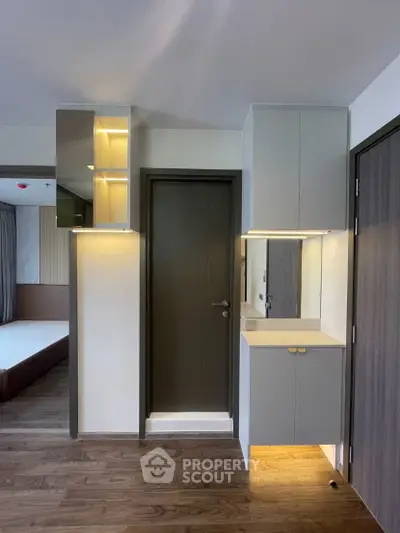 Modern bedroom with sleek cabinetry and stylish lighting