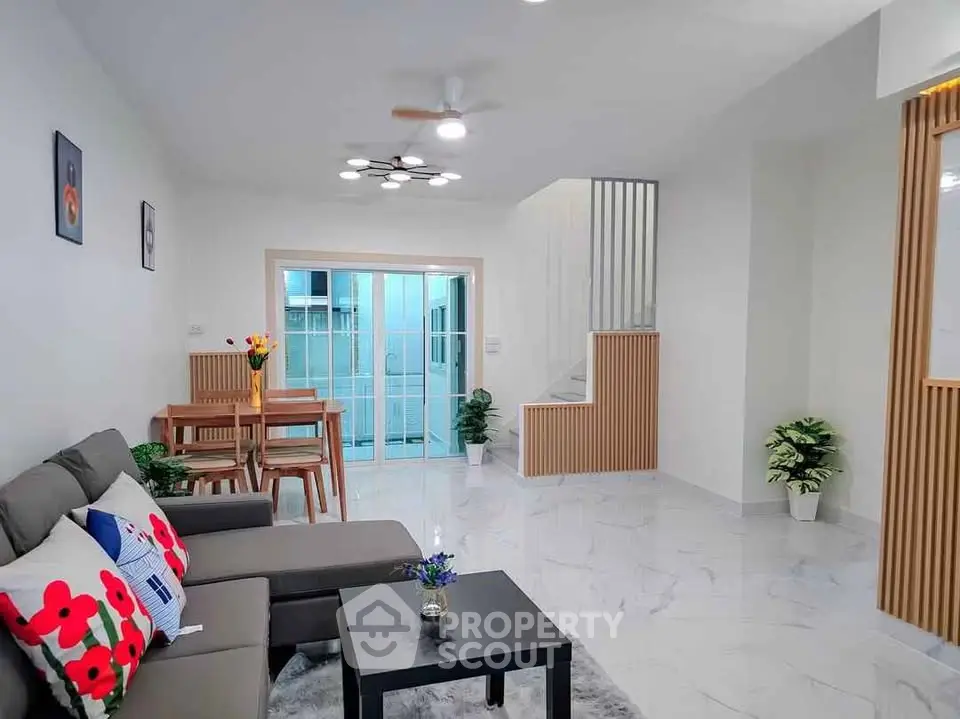Spacious modern living room with stylish decor and open dining area, perfect for family gatherings.