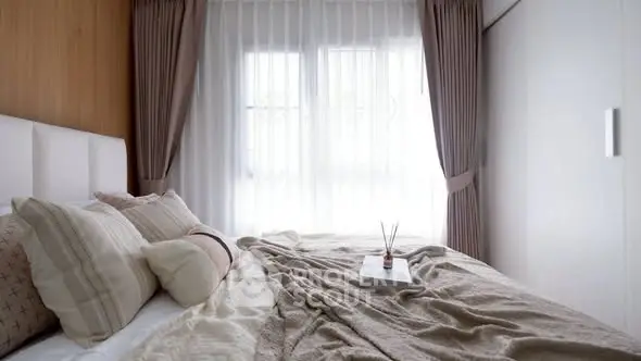 Cozy bedroom with soft lighting and elegant curtains, perfect for relaxation.