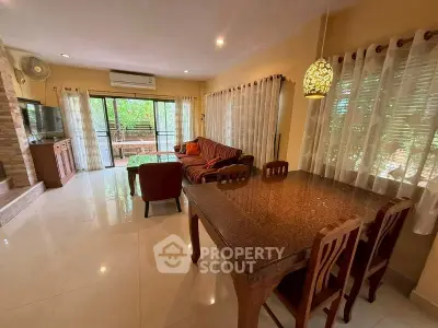 Spacious living room with elegant dining area and garden view, perfect for family gatherings.