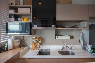 Modern kitchen with sleek cabinetry and built-in appliances, featuring a stylish open layout and contemporary design.