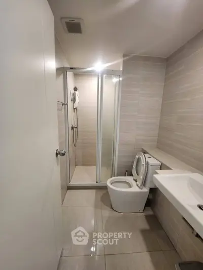 Modern bathroom with sleek shower and contemporary fixtures in a stylish apartment.