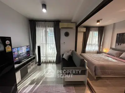 Modern studio apartment with cozy living area and stylish bedroom