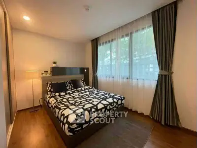 Modern bedroom with stylish decor and large window for natural light