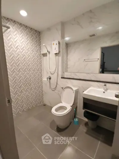 Modern bathroom with sleek tiles and shower in a contemporary apartment.