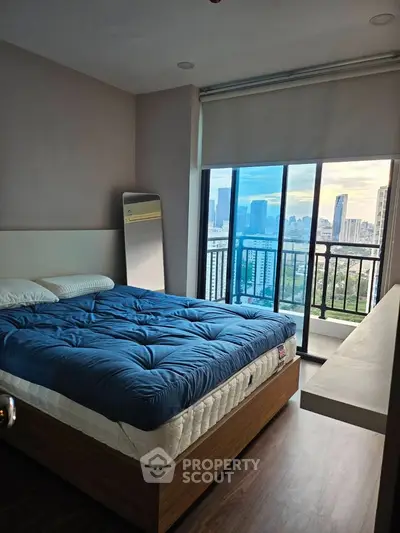 Modern bedroom with city view and large window balcony access