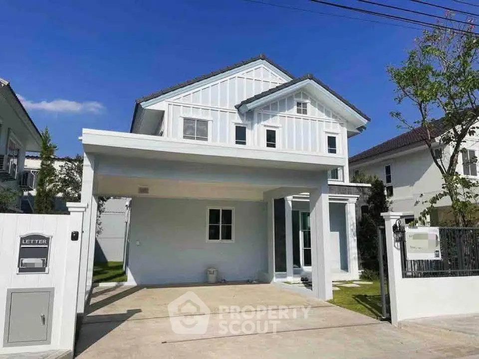 Charming modern house with spacious driveway and elegant facade in a serene neighborhood.