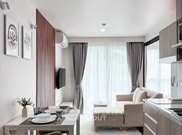 Modern living room with stylish decor and open kitchen layout in a bright apartment.