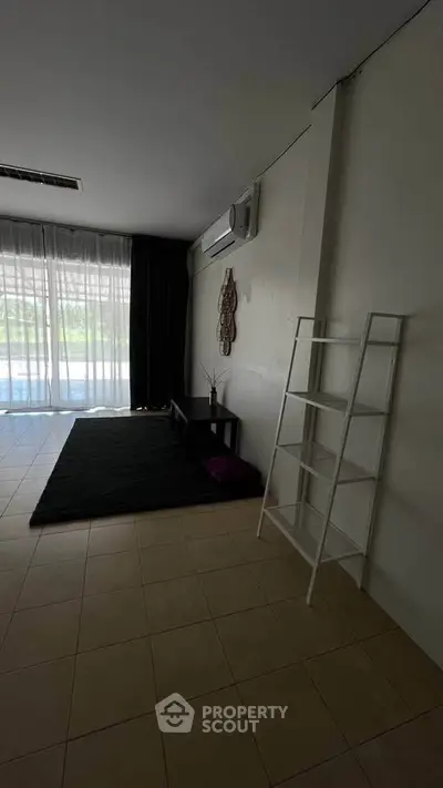 Spacious living room with modern decor and large windows for natural light.