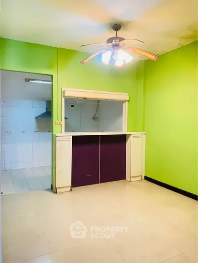 Bright kitchen with open layout and vibrant green walls