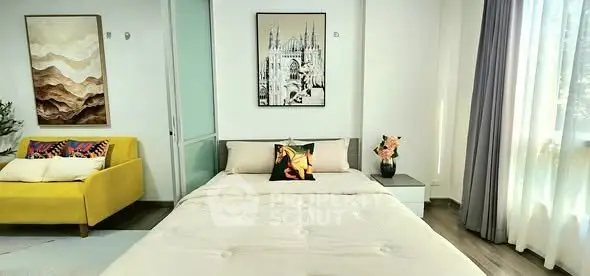 Spacious bedroom with modern decor and large window for natural light