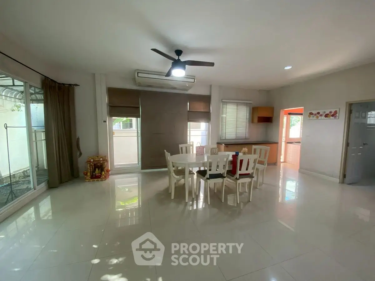 Spacious dining area with modern furniture and large windows for natural light.