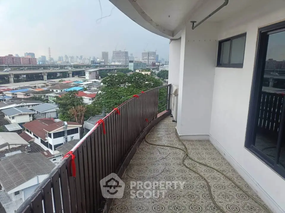 Spacious balcony with city view in high-rise apartment