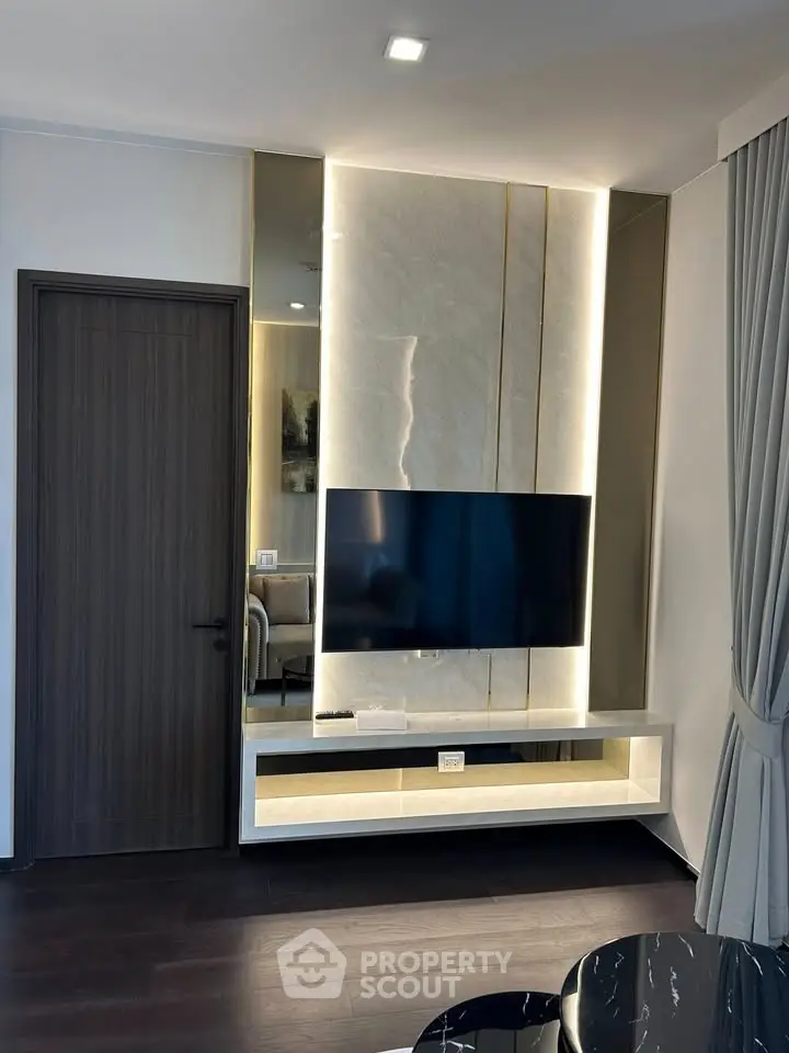 Modern living room with sleek TV setup and elegant lighting