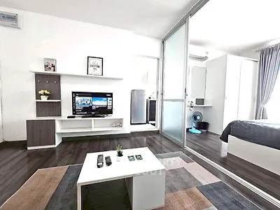 Modern living room with sleek design and open layout, featuring stylish furniture and a cozy atmosphere.