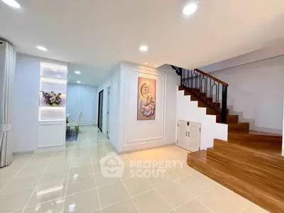 Elegant interior with wooden staircase and modern decor in a spacious living area.