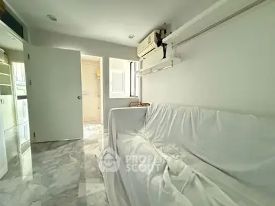 Bright and airy living room with marble flooring and air conditioning, perfect for modern living.