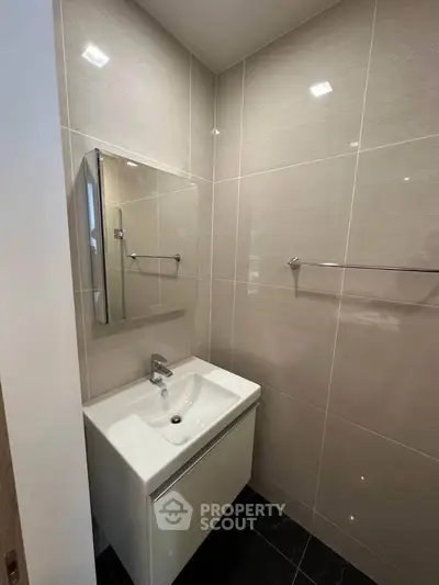 Modern bathroom with sleek sink and mirror in compact space
