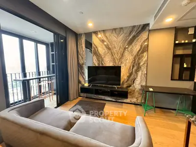 Modern living room with stylish marble accent wall and cozy balcony view.