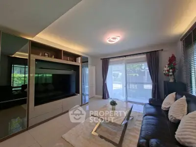 Spacious modern living room with sleek furniture and large windows for natural light.