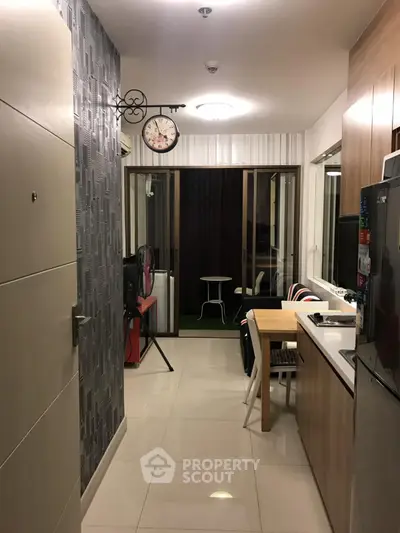 Modern kitchen with sleek design and dining area leading to a cozy balcony.