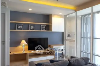 Modern living room with sleek furniture and large windows offering natural light