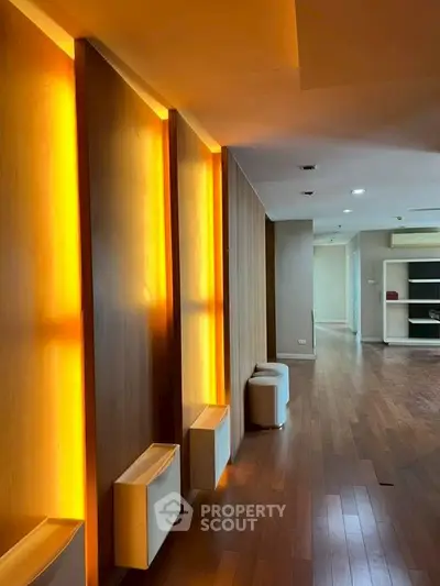 Spacious modern interior with warm lighting and wooden flooring