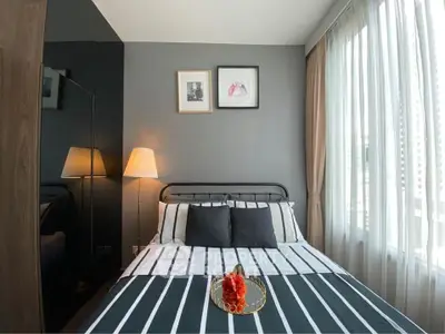 Cozy bedroom with modern decor and large window for natural light