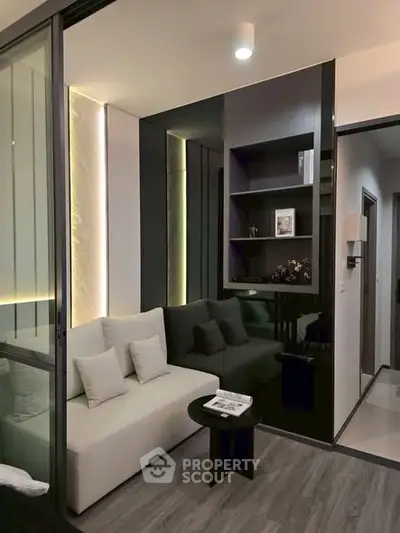 Modern living room with sleek design and ambient lighting, featuring a cozy sofa and stylish shelving.