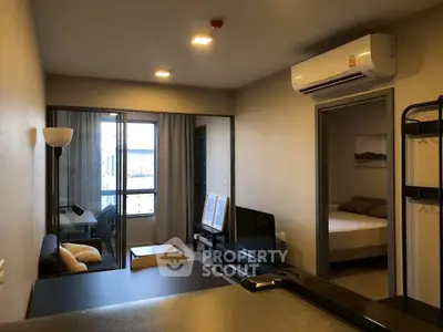 Modern apartment interior with open living room and bedroom, featuring air conditioning and stylish decor.