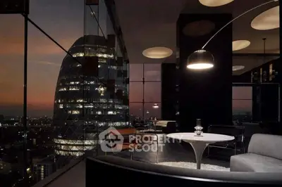 Luxurious modern living room with stunning city view and elegant furnishings at sunset.