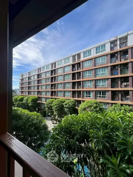 Modern apartment building with lush greenery and clear blue sky view