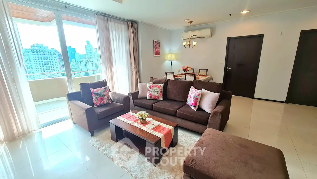 Spacious living room with city view, elegant decor, and cozy seating area.