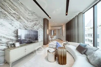 Luxurious modern living room with elegant decor and large windows.