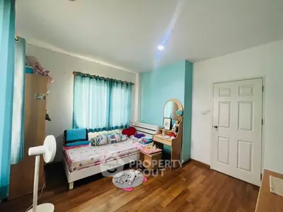 Charming bedroom with wooden flooring and cozy decor