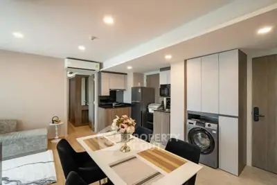 Modern open-plan kitchen and dining area with sleek appliances and stylish decor.