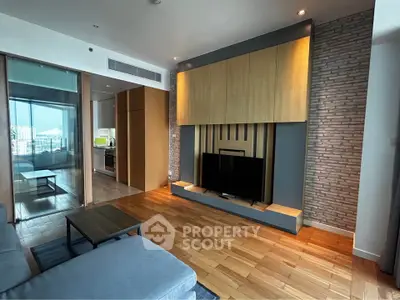 Modern living room with wooden flooring and stylish TV setup