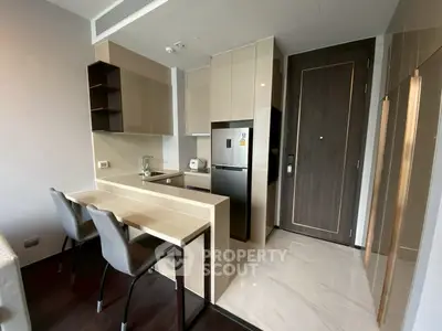 Modern kitchen with sleek cabinetry and breakfast bar in a stylish apartment